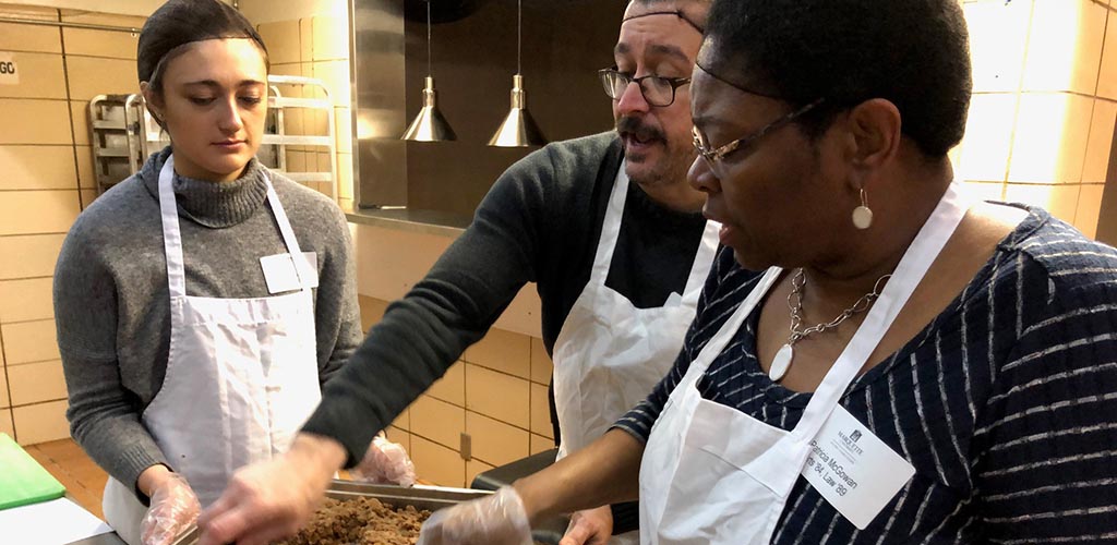 MUAA board members prepare food at the Marquette University Neighborhood Kitchen