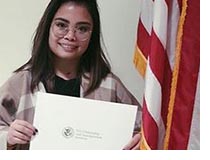 Angela Masajo with citizenship papers.