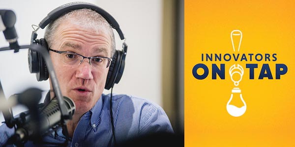 Chuck Swoboda in headphones records his podcast