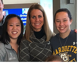 Dean Ropella flanked by students on the left and right